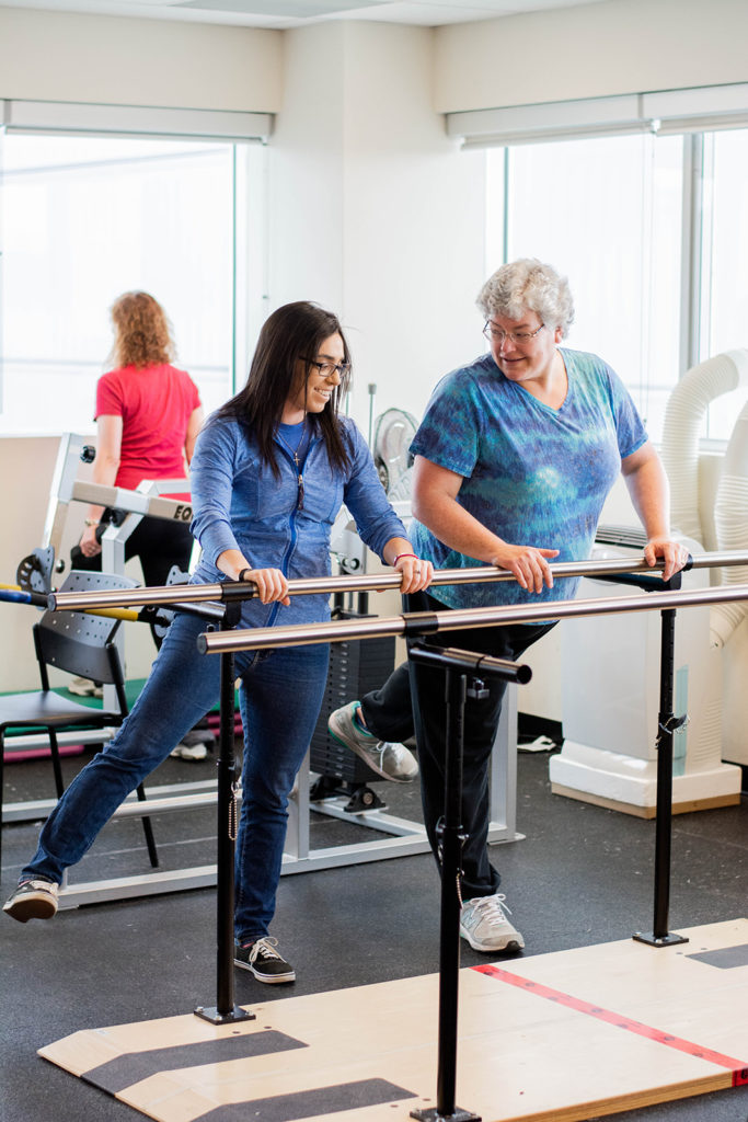 A Revved Up volunteer helping a program member