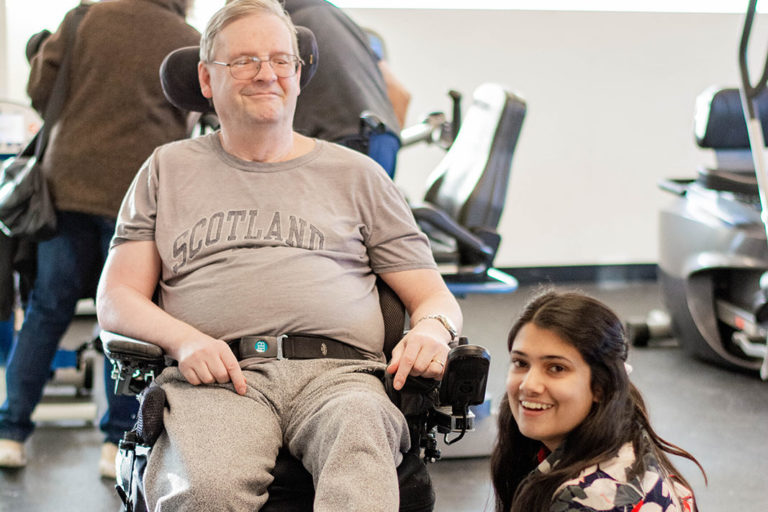 A Revved Up volunteer helping a program member