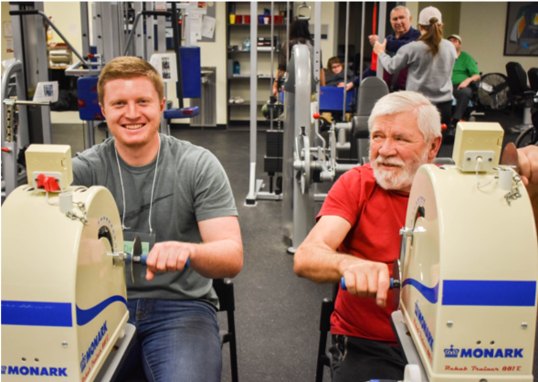 A Revved Up member exercising with a volunteer